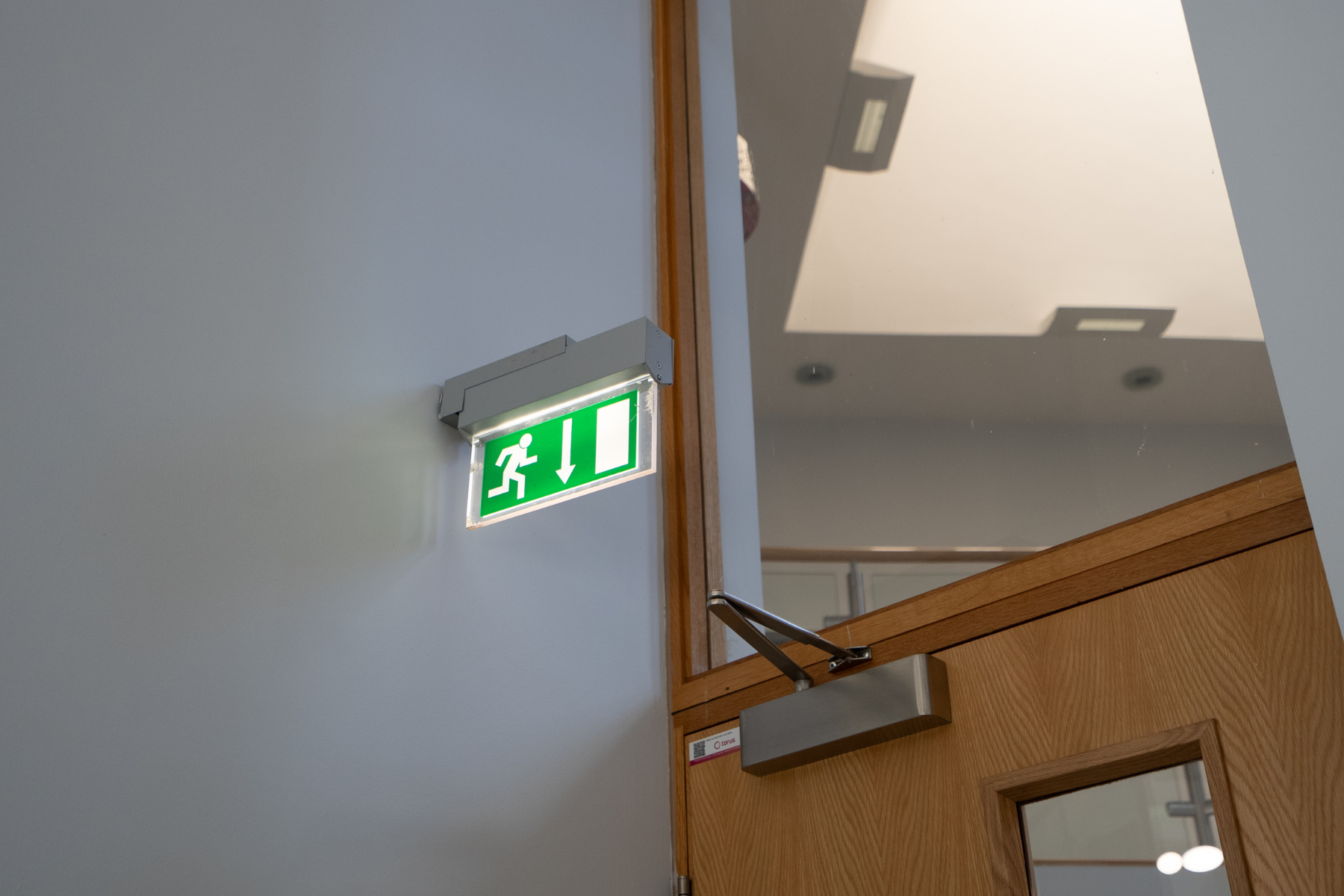 Fire door with slow closer, exit sign and white board surround